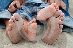 Family feet on sand