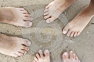 Family feet on sand