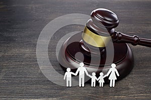 Family figure and gavel on wooden table. Family law concept