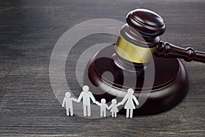Family figure and gavel on wooden table. Family law concept