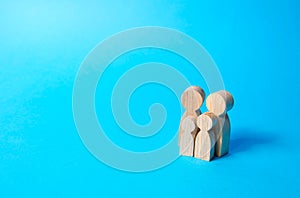 Family figures of parents and kids on a blue background. Family values and health. Adoption and custody of children. Social