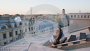 Family filming view of St. Petersburg city while sitting on rooftop