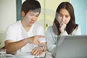 Family financial crisis. Stressed young couple looking at issues notification from bank about late payment home loan credit