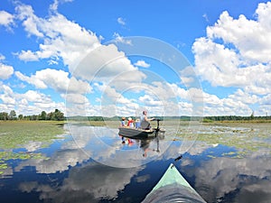 Family Fishing and Relaxing on Boats on a Pristine Secluded Lake on Summer Day