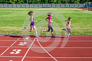 Family fitness, mother and kids running on stadium track, training and children sport healthy lifestyle