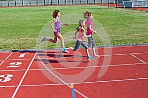 Family fitness, mother and kids running on stadium track, training and children sport healthy lifestyle