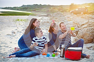 Family of five doing selfy at the picnic on the beach
