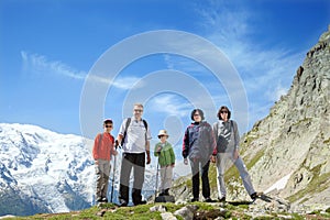 The family from five persons stays against massif of Mont Blanc photo
