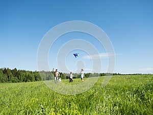 Family Flying Kite Together Outdoors