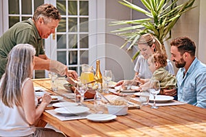 Family, food and love with a man, woman and parents eating a meal together around a dining room table. Children, dinner