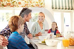 Family, food and parents with children for breakfast, eating and bonding together in dining room. Smile, happy mother