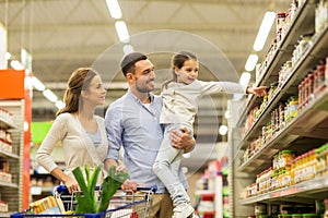 Family with food in shopping cart at grocery store