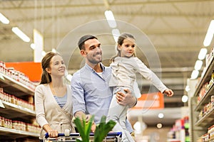 Family with food in shopping cart at grocery store