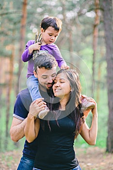 Family in the forest. Mom dad and daughter for a walk in the woods