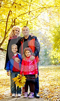 Family of four in autumn park