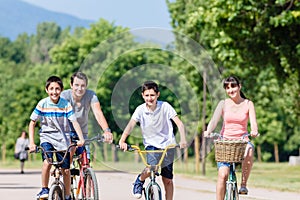 Family of four on bike tour in summer