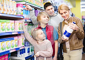 Family of four buying pasteurized milk photo