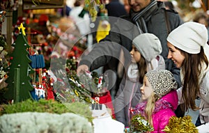 Family of four choosing x-mas decorations