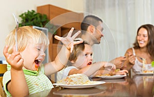 Family of four eating spaghetti