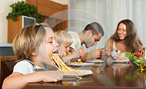 Family of four eating spaghetti