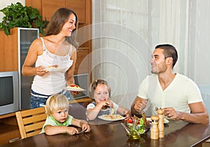 Family of four eating spaghetti