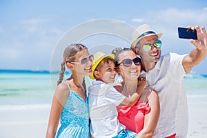 Family of four having fun at the beach