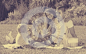 Family of four having picnic