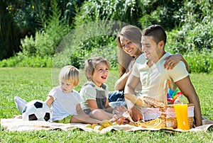Family of four having picnic