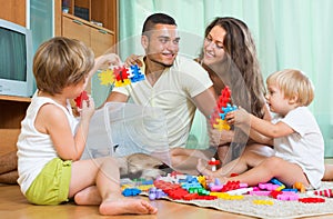 Family of four at home with toys