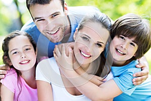 Family of four hugging each other