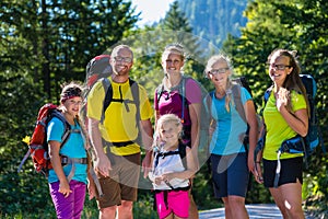 Family with four kids hiking in the mountains