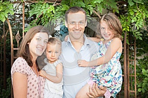 family of four outdoor portrait with two blue eyes daughter child girl