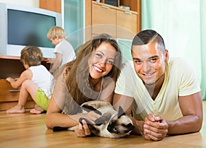 Family of four playing with kitten