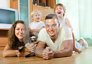 Family of four playing with kitten