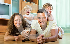 Family of four playing with kitten