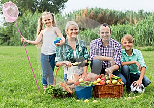 Family of four resting at countryside