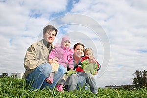 Family of four sit