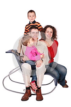 Family of four sits on chair