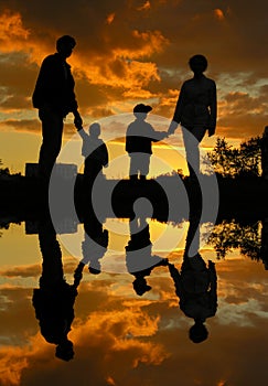 Family of four sunset water