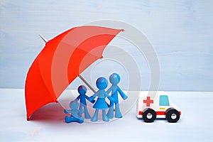 Family of four under a blue red umbrella