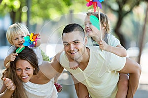 Family of four walking with children on vacation