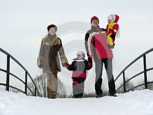 Family of four on winter bridge