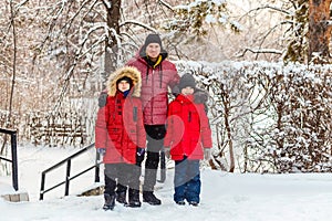 Family of four in winter clothes in winter in the park