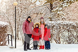 Family of four in winter clothes in winter in the park