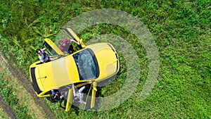 Family and friends car travel on vacation, happy parents and kids in holiday trip, aerial drone view of car and people from above