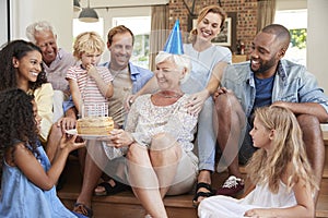 Family and friends celebrating grandmaï¿½s birthday, close up