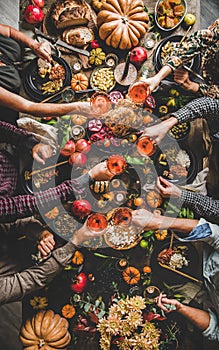 Family or friends celebrating Thanksgiving day clinking glasses with champagne