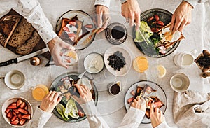 Family or friends having breakfast or brunch together, top view