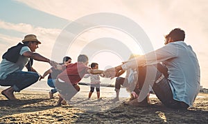 Family friends having fun on the beach at sunset - Fathers, mothers, children and uncles playing together - Love, relationship, photo