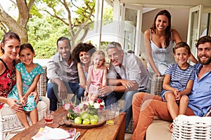 Family and friends posing for a picture in a conservatory